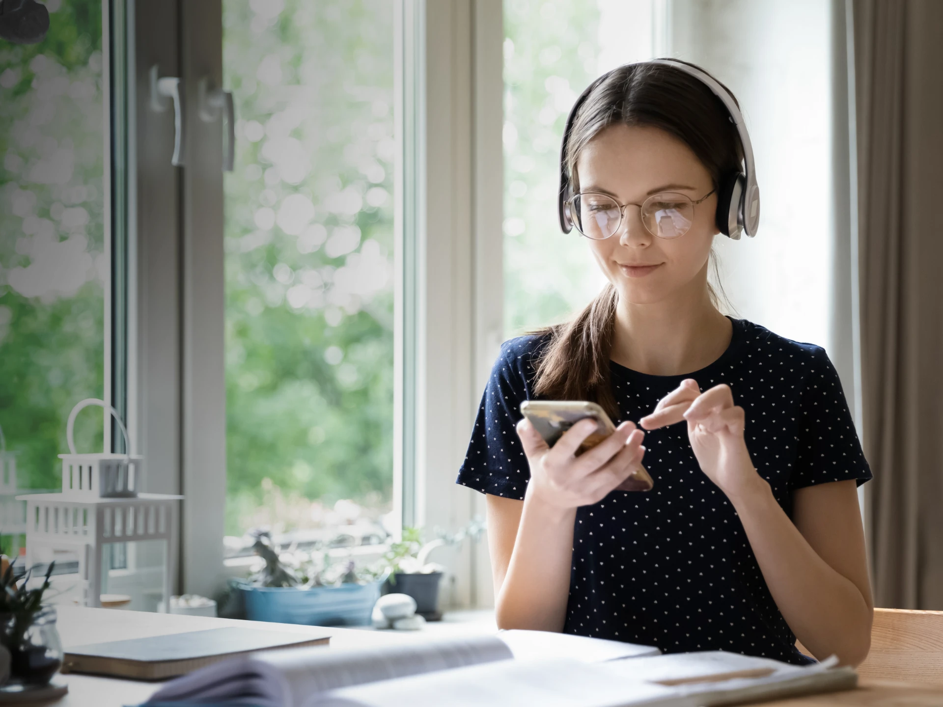 A large background image of student studying at a desk